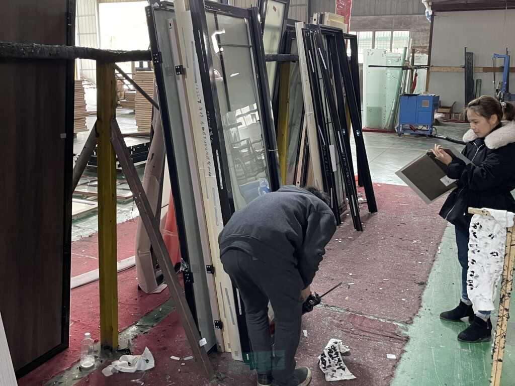 V7proX team inspecting aluminum window frames before shipping