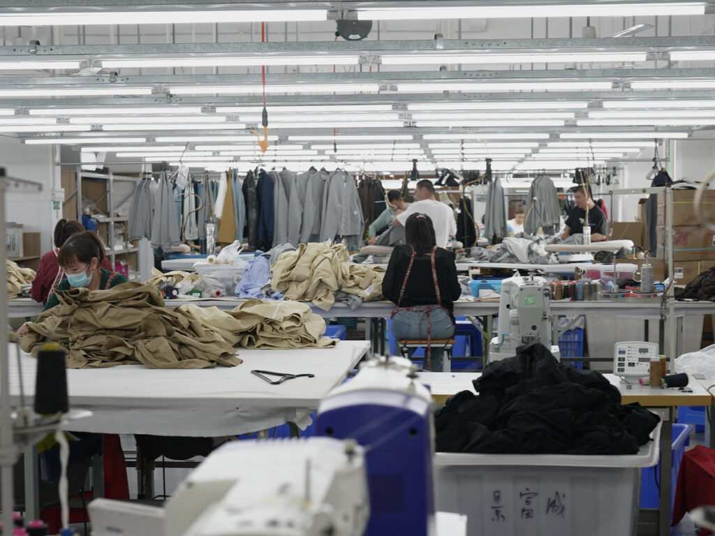 A verified custom streetwear manufacturer China showcasing premium heavyweight garments on the factory floor.