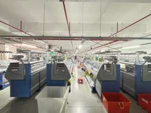 A row of circular knitting machines operating at an activewear manufacturer China facility in Guangdong