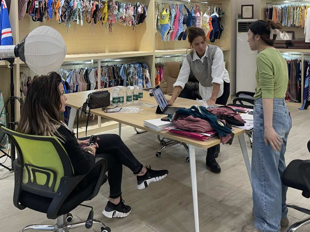 Checking fabric shrinkage against an activewear tech pack on the factory floor